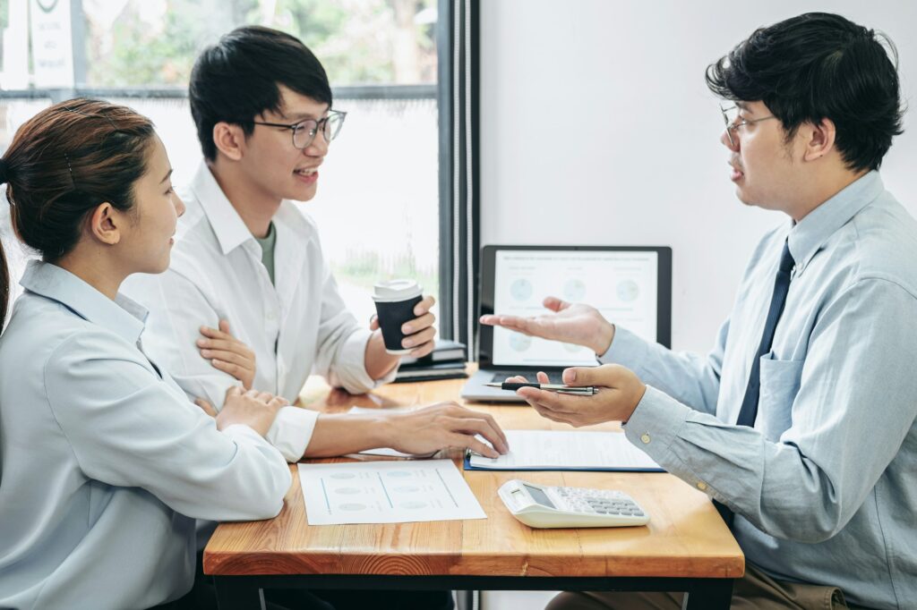 Asian couple drinking coffee cup and meeting with financial advi