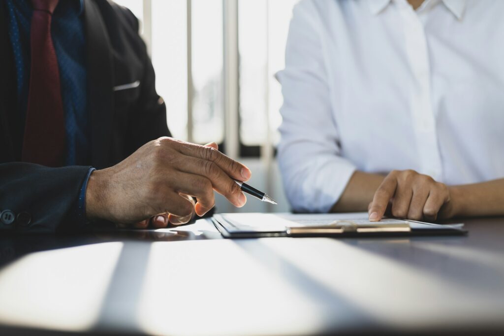 Businessman showing an insurance policy to sign. Insurance agent consulting insurance to customer.