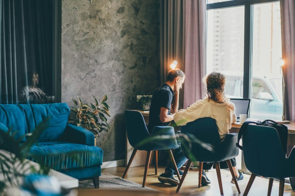 Family of middle aged man and woman at work together on project