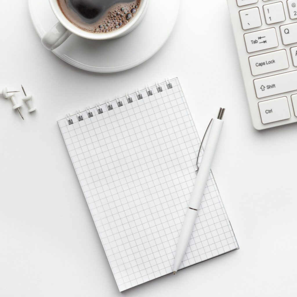 Office Table With Notepad, Computer And Coffee Cup